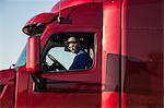 Portrait of a Caucasian man, a truck driver and truck owner.