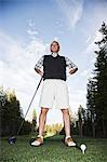 Senior golfer teeing off during a round of golf.