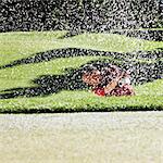 Senior golfer playing out of a bunker on the golf course.