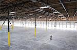 Owner checking out the new interior of a large empty warehouse space.