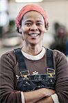 Black woman factory worker in a sheet metal factory.