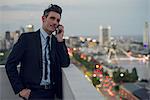 Businessman talking on mobile phone outdoors