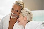 Couple in bathrobes smiling