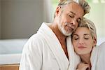 Couple in bathrobes embracing