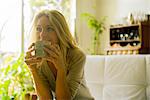 Mature woman drinking coffee at home