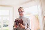 Mature woman reading diary