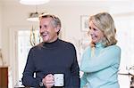 Laughing mature couple drinking tea