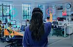 Businesswoman using futuristic hologram computer in office