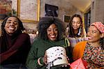 Portrait smiling, happy family opening Christmas gifts