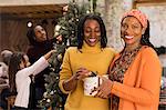 Portrait smiling women sisters holding Christmas gift