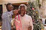 Grandson surprising grandfather with Christmas gift