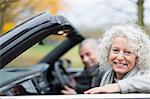 Portrait smiling senior couple in convertible