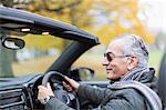 Senior man driving convertible