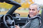 Portrait smiling, confident senior man in convertible