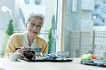 Senior woman having meal