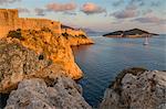 View to Lovrijenac Fortress (St. Lawrence Fortress), the city walls and Lokrum Island at sunset, Croatia, Europe