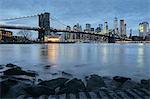 Cityscape with Brooklyn Bridge and Lower Manhattan skyline at dusk, New York, USA