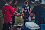 Father lighting sparklers for group of children