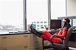 A black office superhero business woman sits in her office and ponders her next business move.