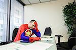 A middle aged Caucasian office super hero ponders the stress of the job.