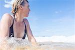 Woman in sea, looking away, low angle view, Nacpan Beach, Palawan, Philippines