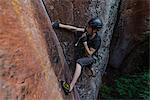 Rock climber climbing sandstone rock, elevated view, Liming, Yunnan Province, China