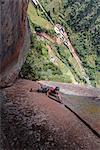 Rock climber climbing sandstone rock, elevated view, Liming, Yunnan Province, China