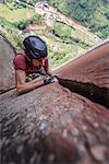 Rock climber climbing sandstone rock, overhead view, Liming, Yunnan Province, China