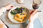 Woman having vegan meal in restaurant