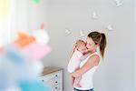 Mother and baby in nursery room