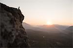 Woman on hilltop at sunrise, Rattlesnake Ledge, Washington, USA