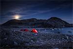 Landscape with tents by fjord and full moon at night, Narsaq, Vestgronland, South Greenland