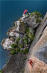 Man rock climbing on limestone rock, overhead view, Ha Long Bay, Vietnam