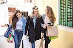 Friends out shopping and laughing in street