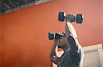 Man using dumbbells in gym
