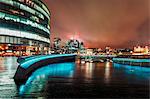 View of London skyline and Tower of London visible in background at night, Southwark, London, England, United Kingdom, Europe