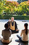 Japanese priest preaching to women at a temple