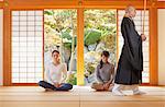 Japanese priest preaching to women at a temple