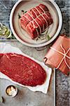 Still life of beef with butcher paper on a metal background