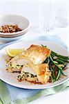 Stuffed chicken wrapped in phyllo pastry with almond green beans on the side