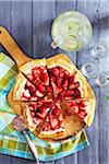 Strawberry dessert pizza on a board with limeade