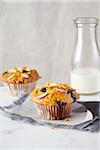 Blueberry almond muffins and bottle of milk in the background