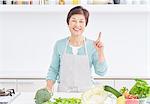 Japanese senior woman with vegetables in the kitchen
