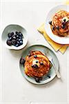 Oatmeal pancakes with blueberries and blackberries served with butter and maple syrup