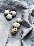Quail eggs on linen, overhead view