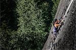 Female rock climber, climbing granite rock (The Chief), elevated view, Squamish, Canada