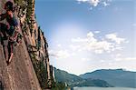 Female rock climber, climbing granite rock (The Chief), low angle view, Squamish, Canada