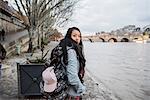 Portrait of young female tourist by river Seine, Paris, France