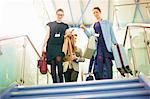 Businesswomen moving down airport stairway