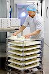 Cheese maker packing cheeses to send off to suppliers